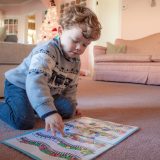 Young boy playing with file folder game