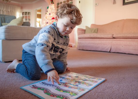 Young boy playing with file folder game