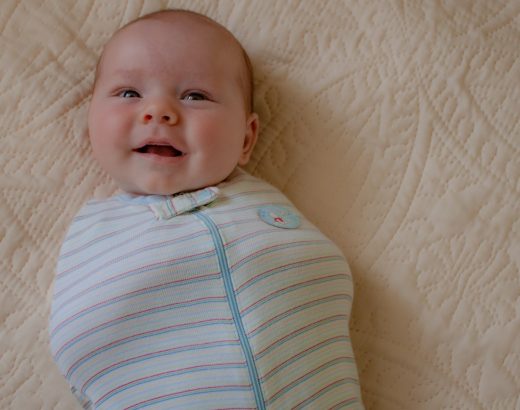 Smiling baby wearing DIY swaddle