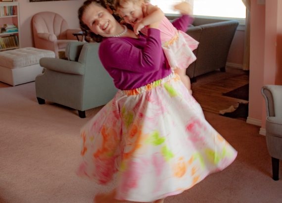 Mother and toddler girl twirling in matching circle skirts